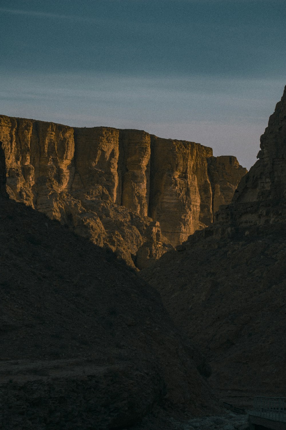 a mountain range with a large rock formation in the background