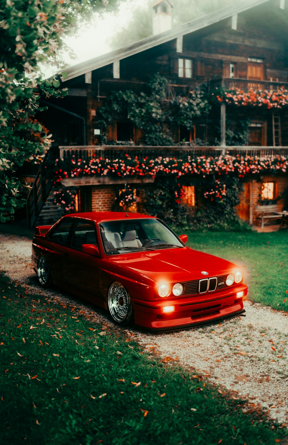 a red car parked in front of a house