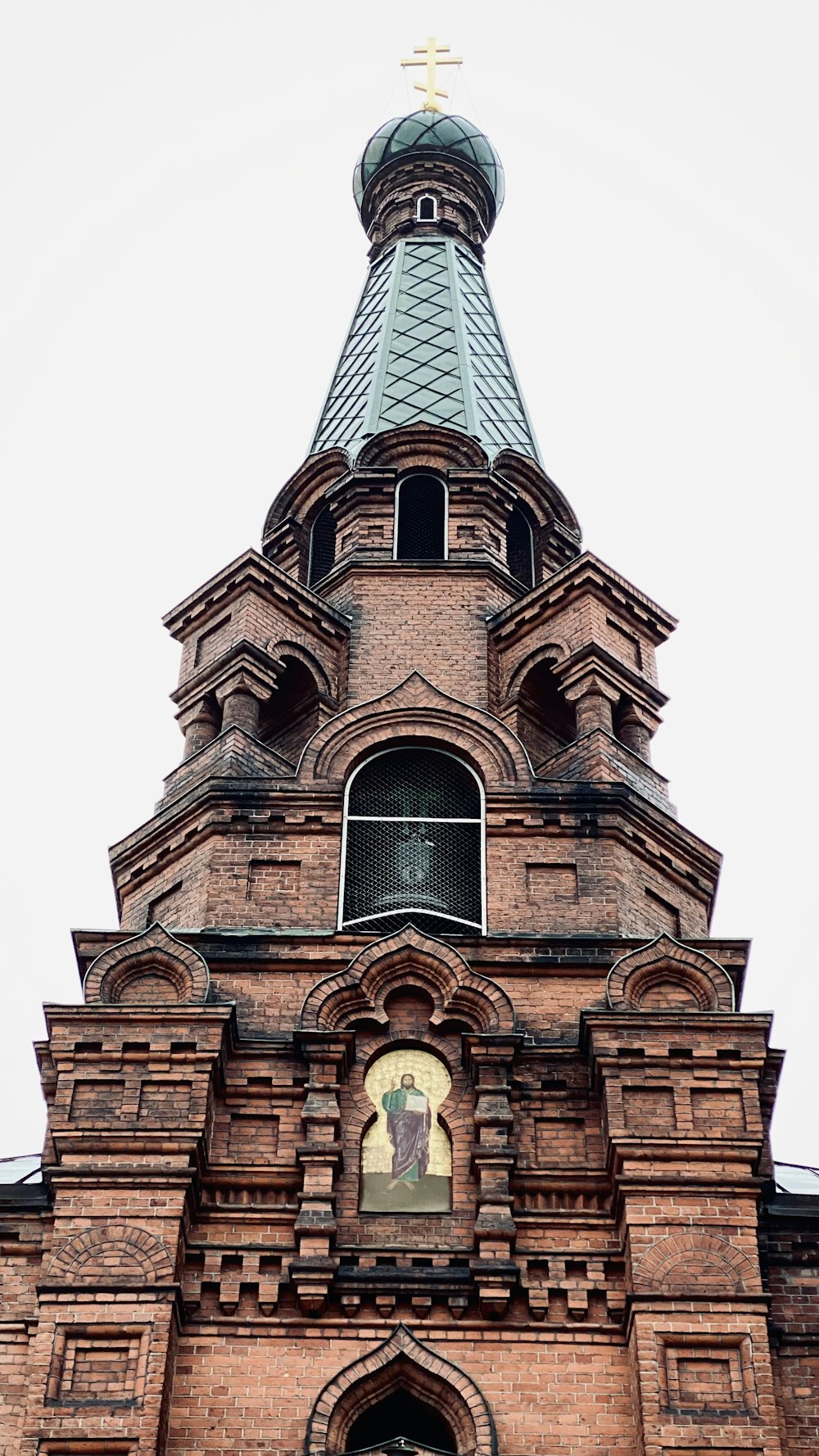 a tall brick building with a clock on it's side