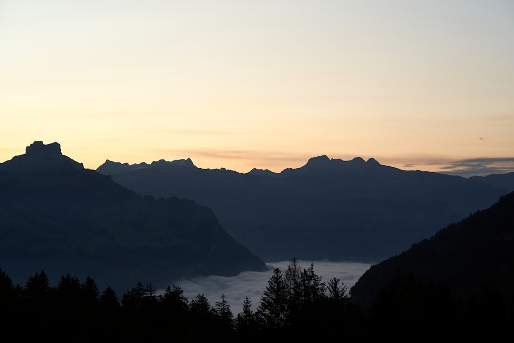 a view of a mountain range with a lake in the foreground