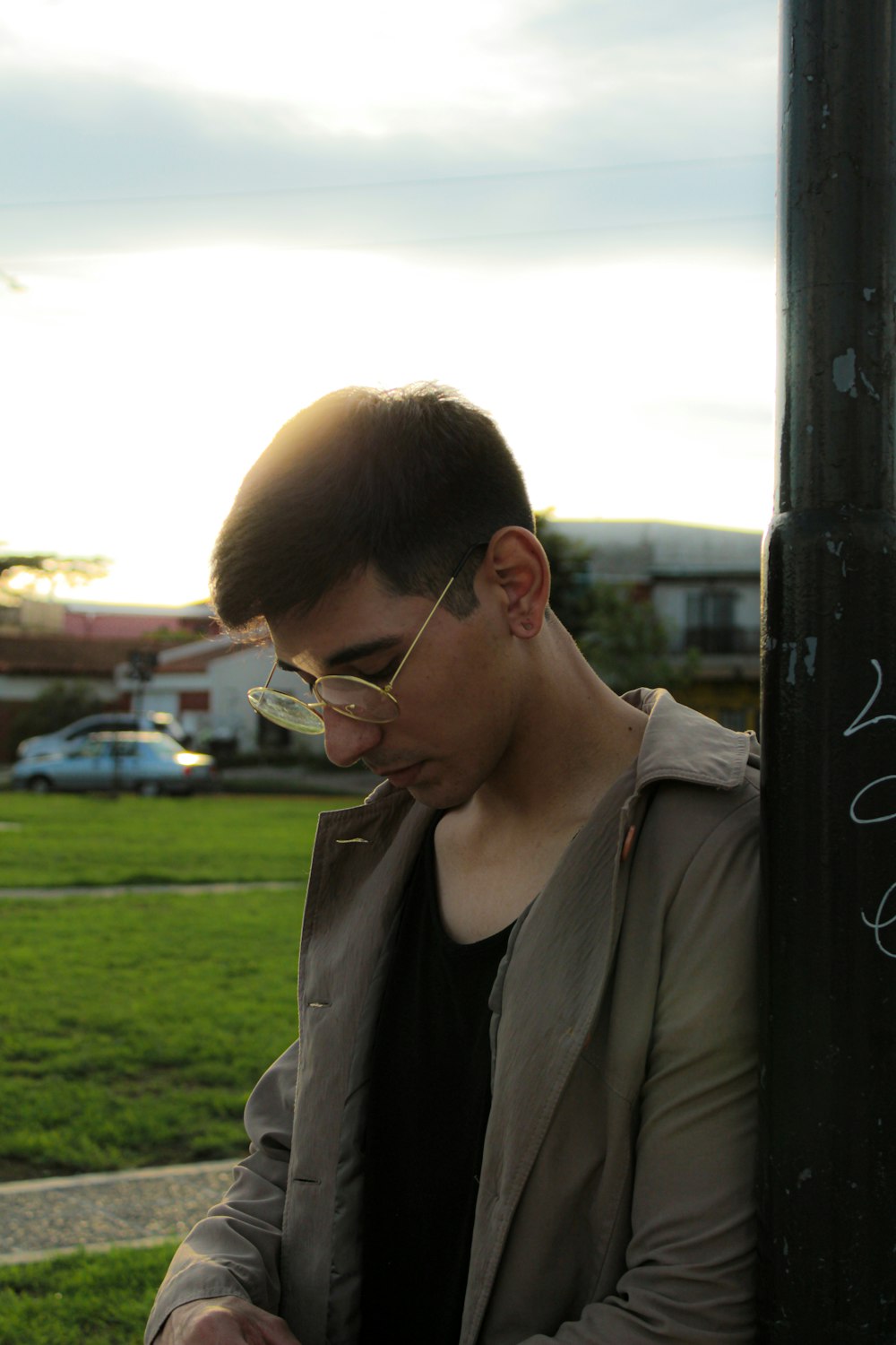 a man sitting on a bench using a cell phone