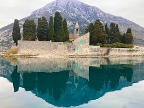a large body of water next to a mountain