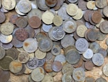 a pile of different types of coins