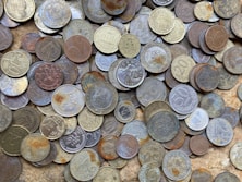 a pile of different types of coins