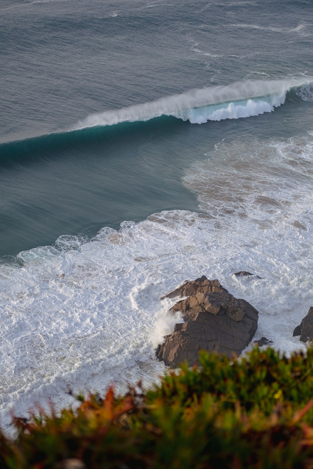 a person riding a surfboard on a wave in the ocean