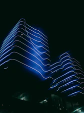 A sleek, neon-lit architectural blueprint glowing against a dark backdrop.