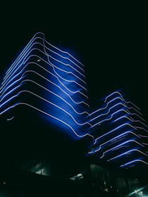 A sleek, neon-lit architectural blueprint glowing against a dark backdrop.