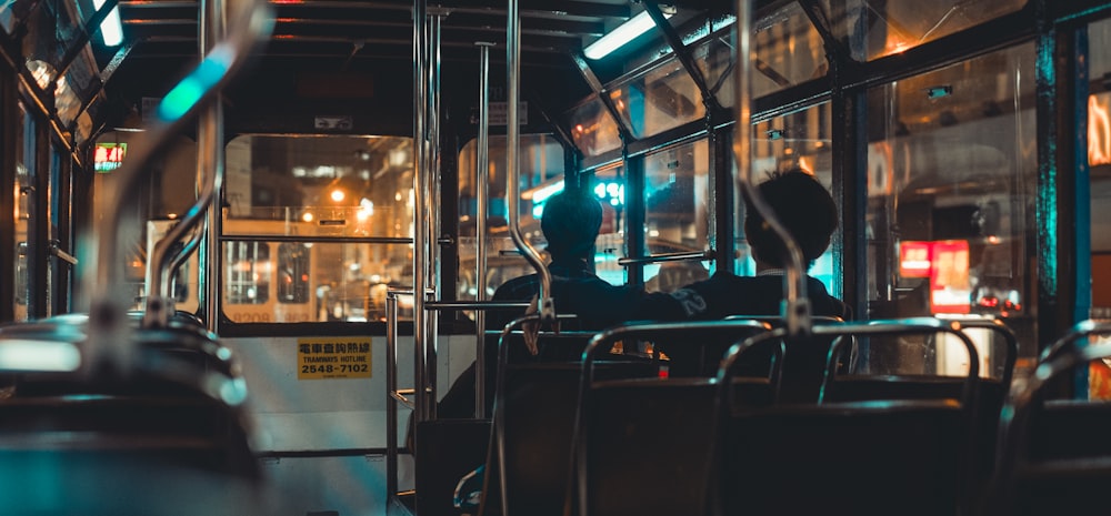 a person sitting on a bus at night