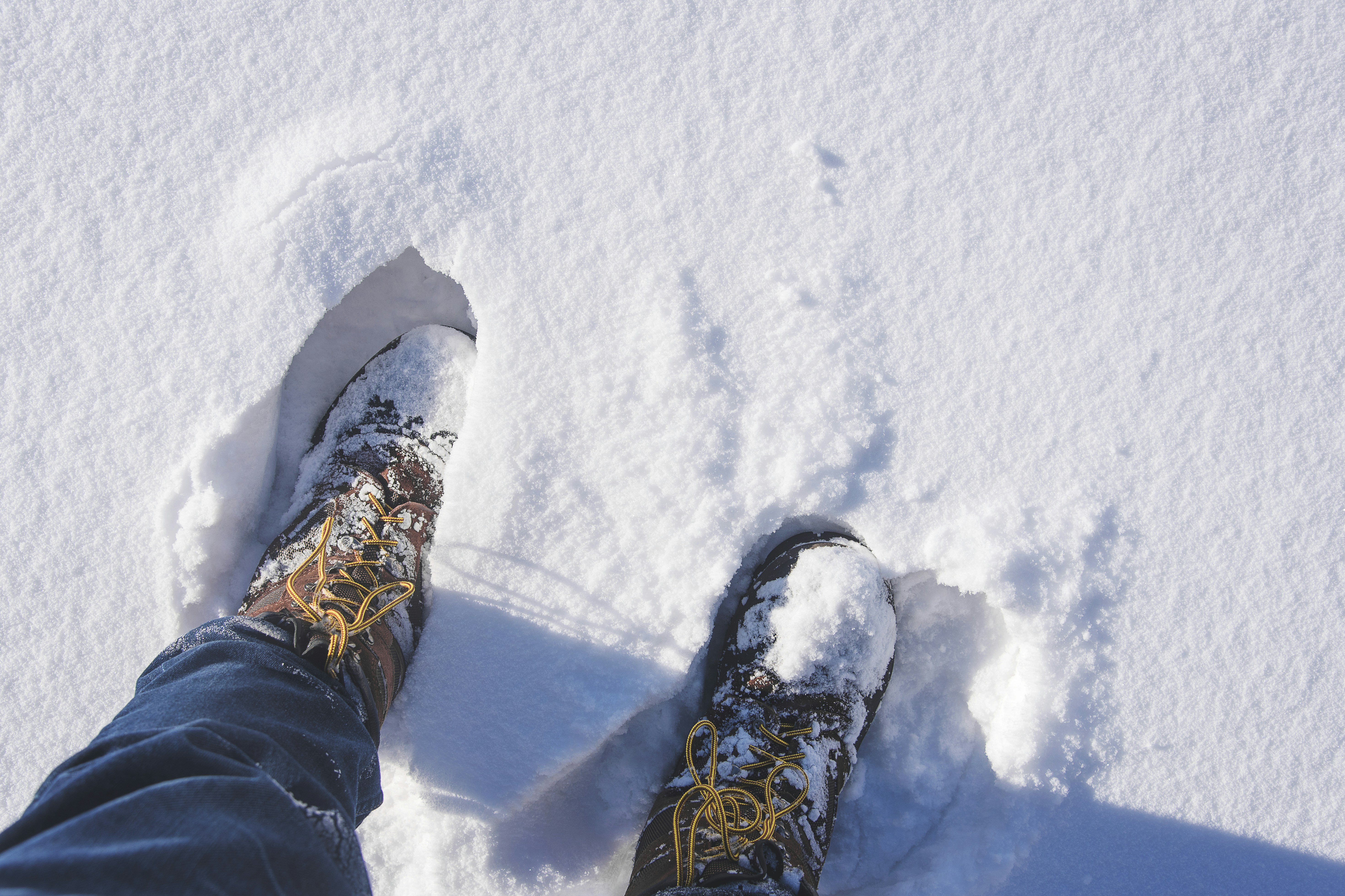 a person standing in the snow with their feet in the snow