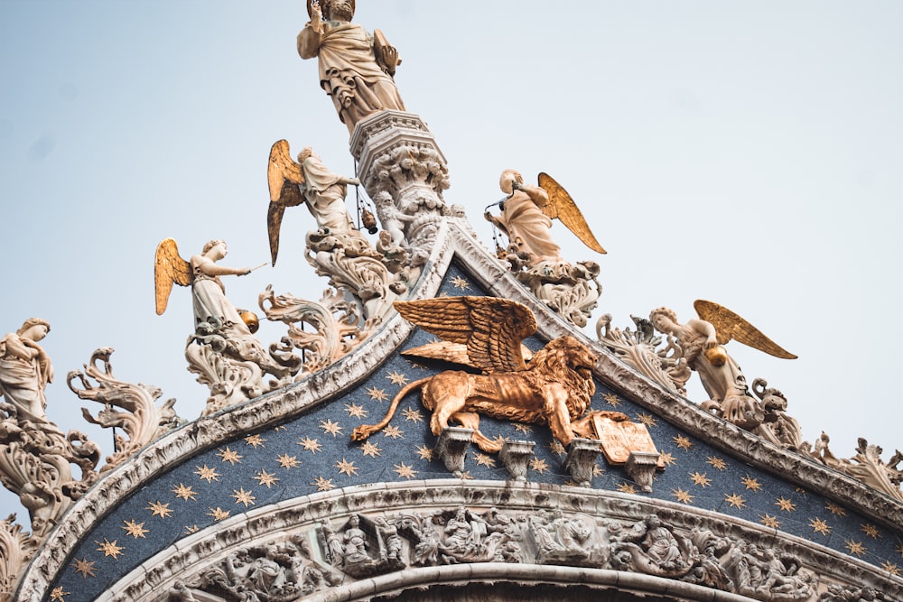 a close up of a building with statues on it