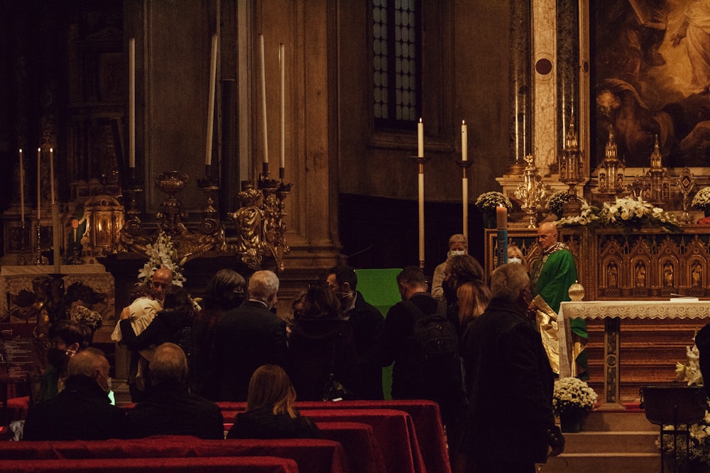 a group of people standing around a church