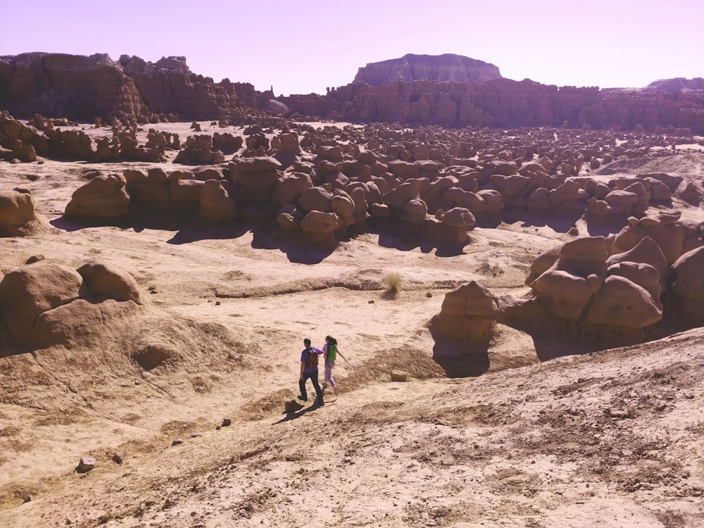 a couple of people that are standing in the dirt