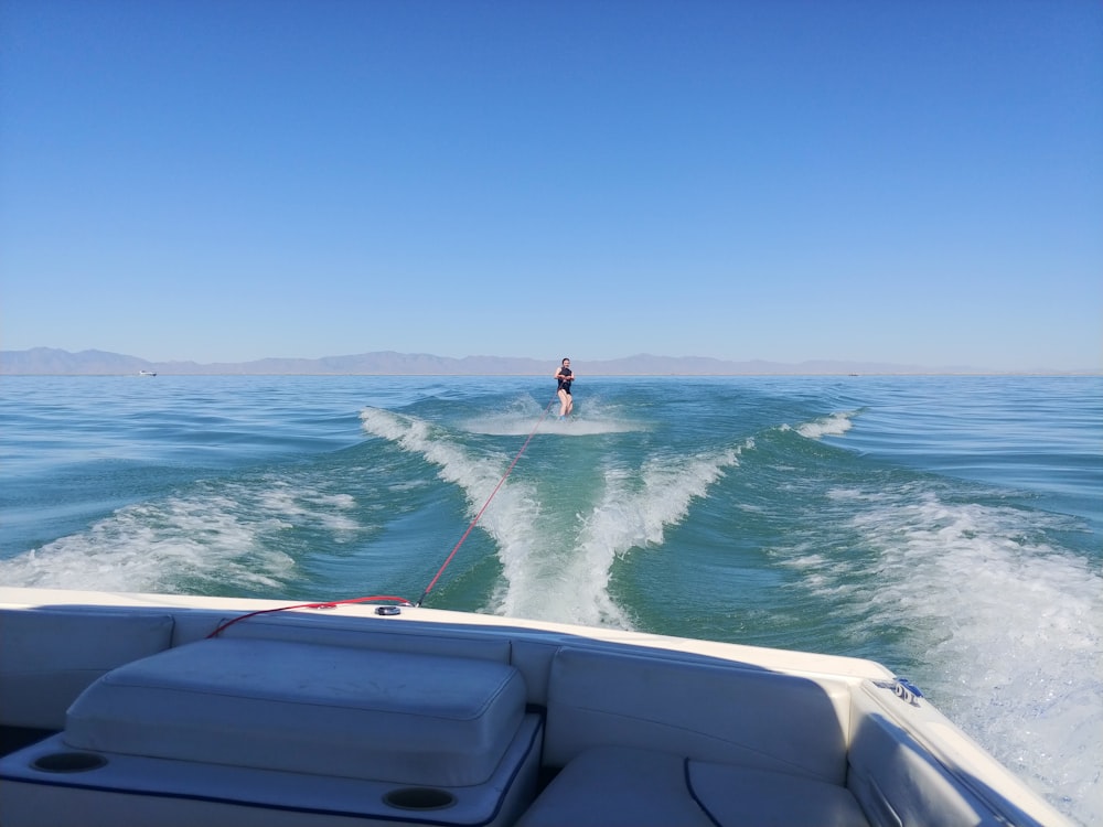 a man riding a boat on top of a body of water