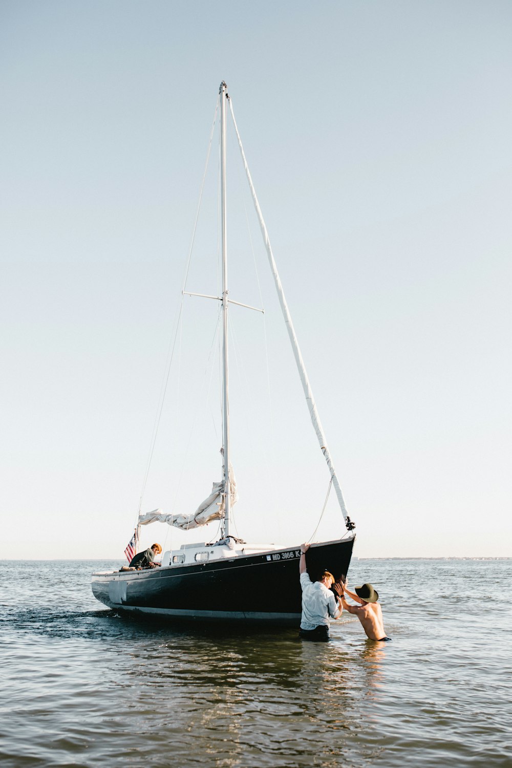 a couple of people standing on top of a boat in the water