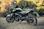 a black motorcycle parked in a grassy field