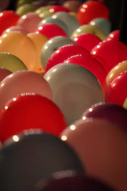 a bunch of balloons are lined up in a row