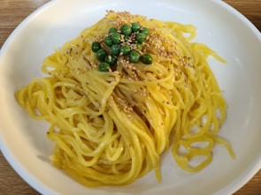 A colorful mess of mashed peas and spaghetti on a high chair tray after a spirited lunch.