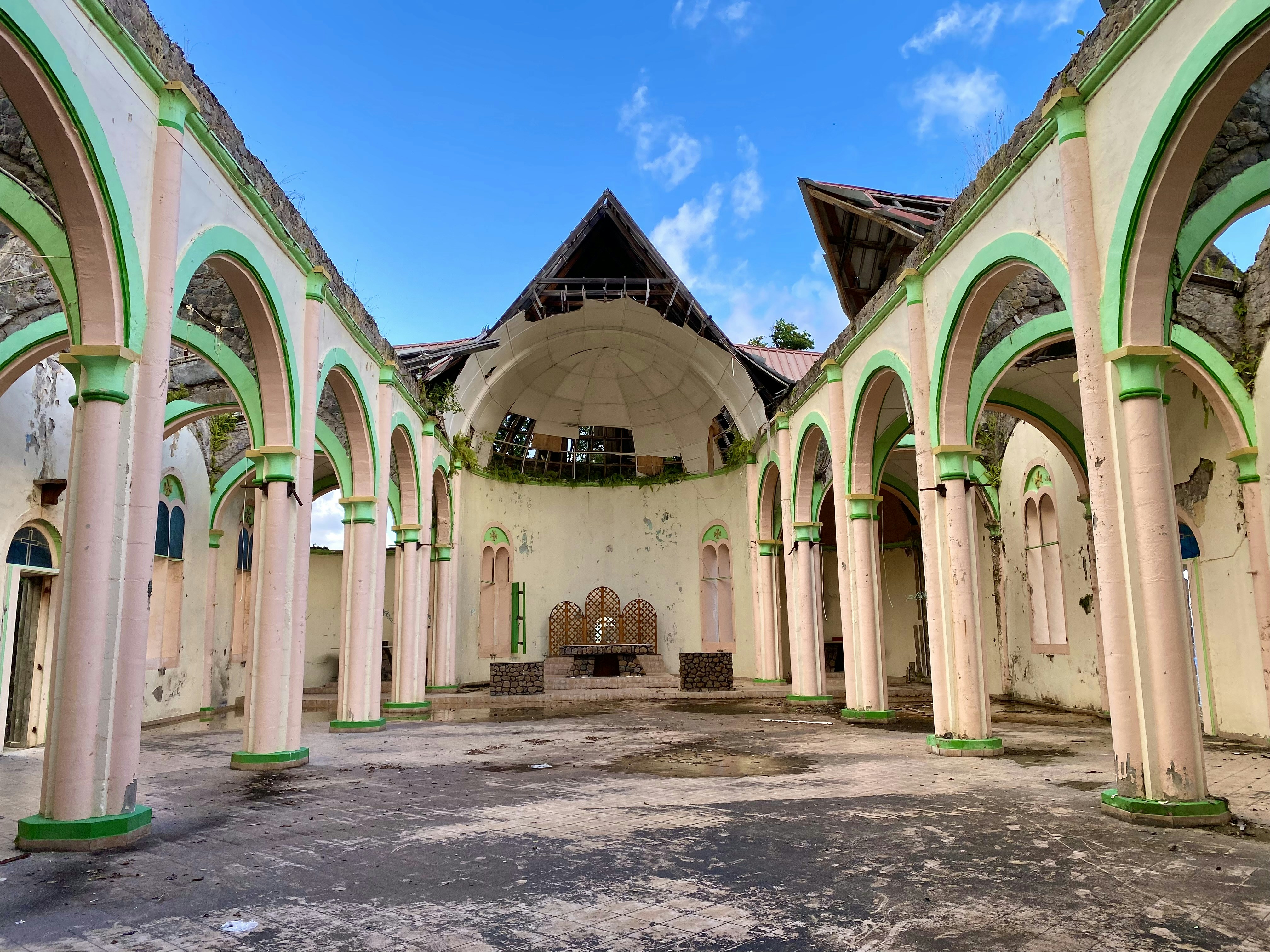 an old building with arches and a clock on the wall, Hurricane Shattered Church