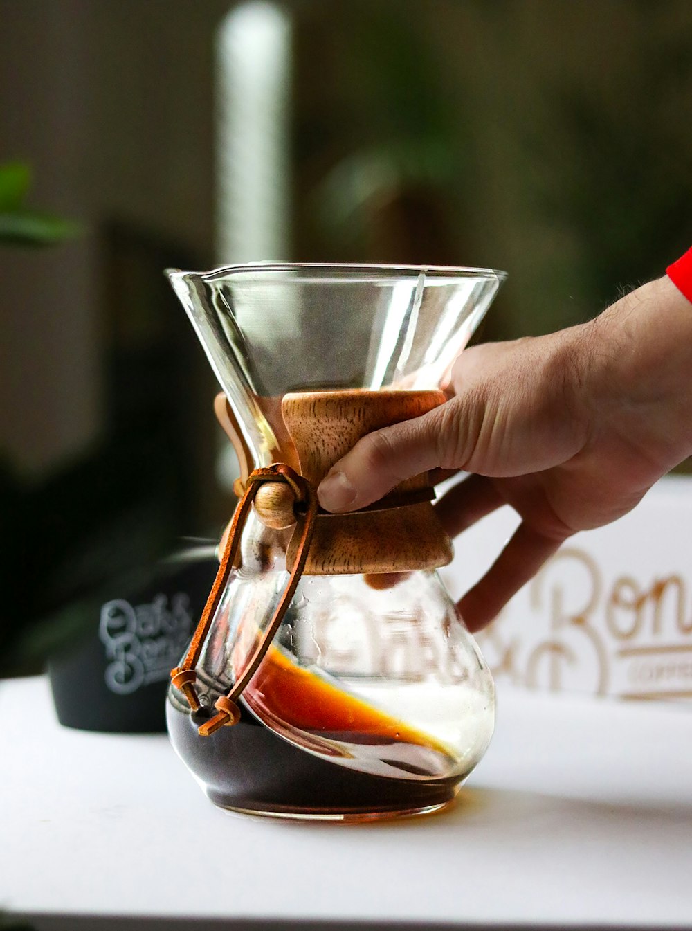 a person is pouring a drink into a glass