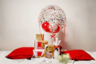 a bunch of presents are on a bed