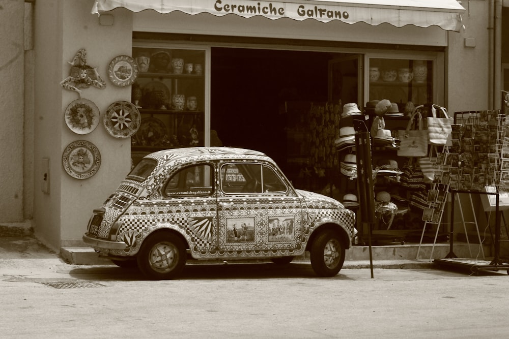 a small car parked in front of a store