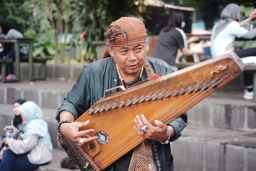 a man is playing a musical instrument outside