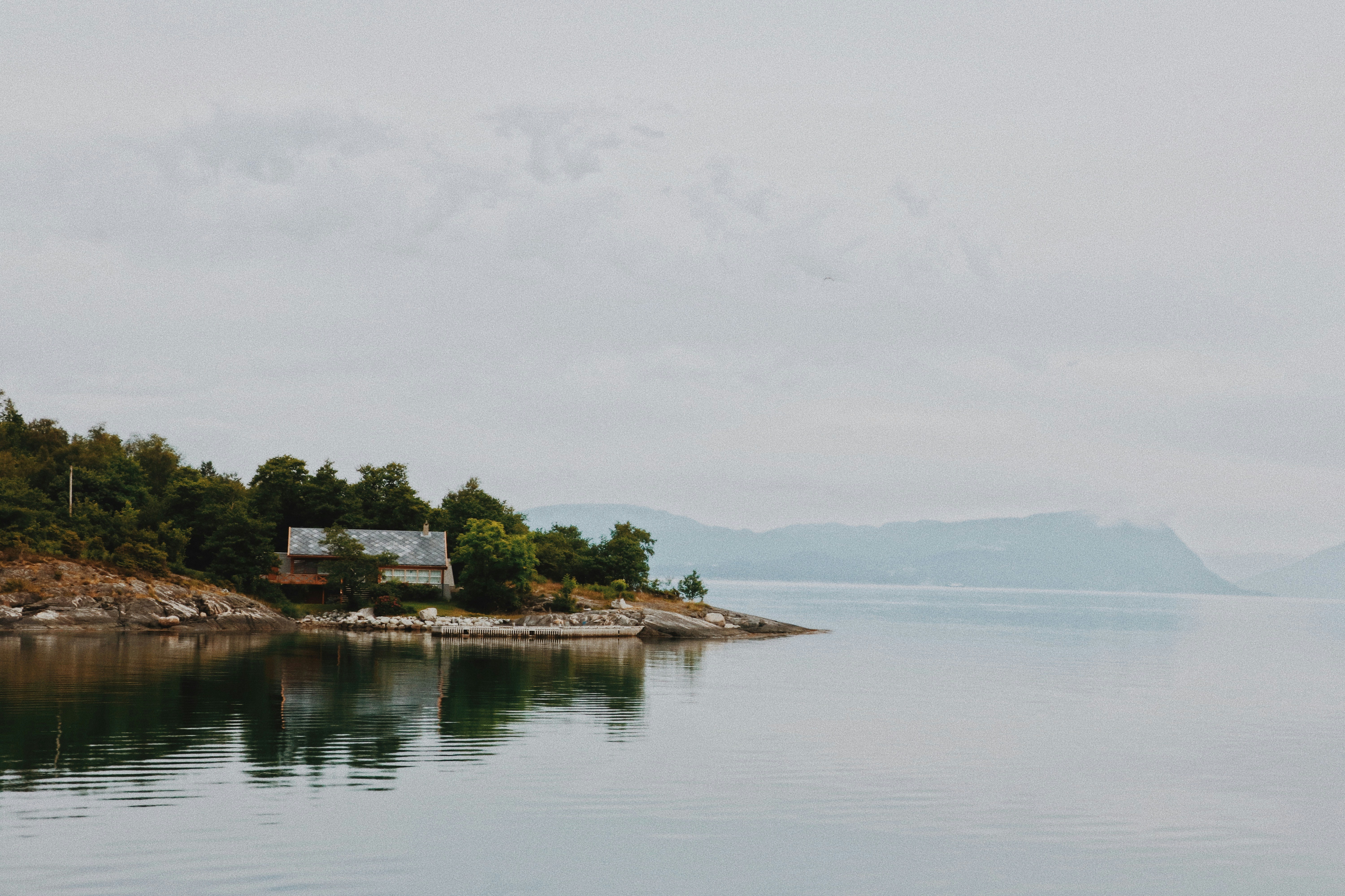 a house on a small island in the middle of a lake