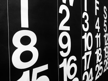 A close-up view of a modern black and white calendar featuring bold, large numbers representing days of the month. The numbers are arranged vertically with a sleek and minimalist design.