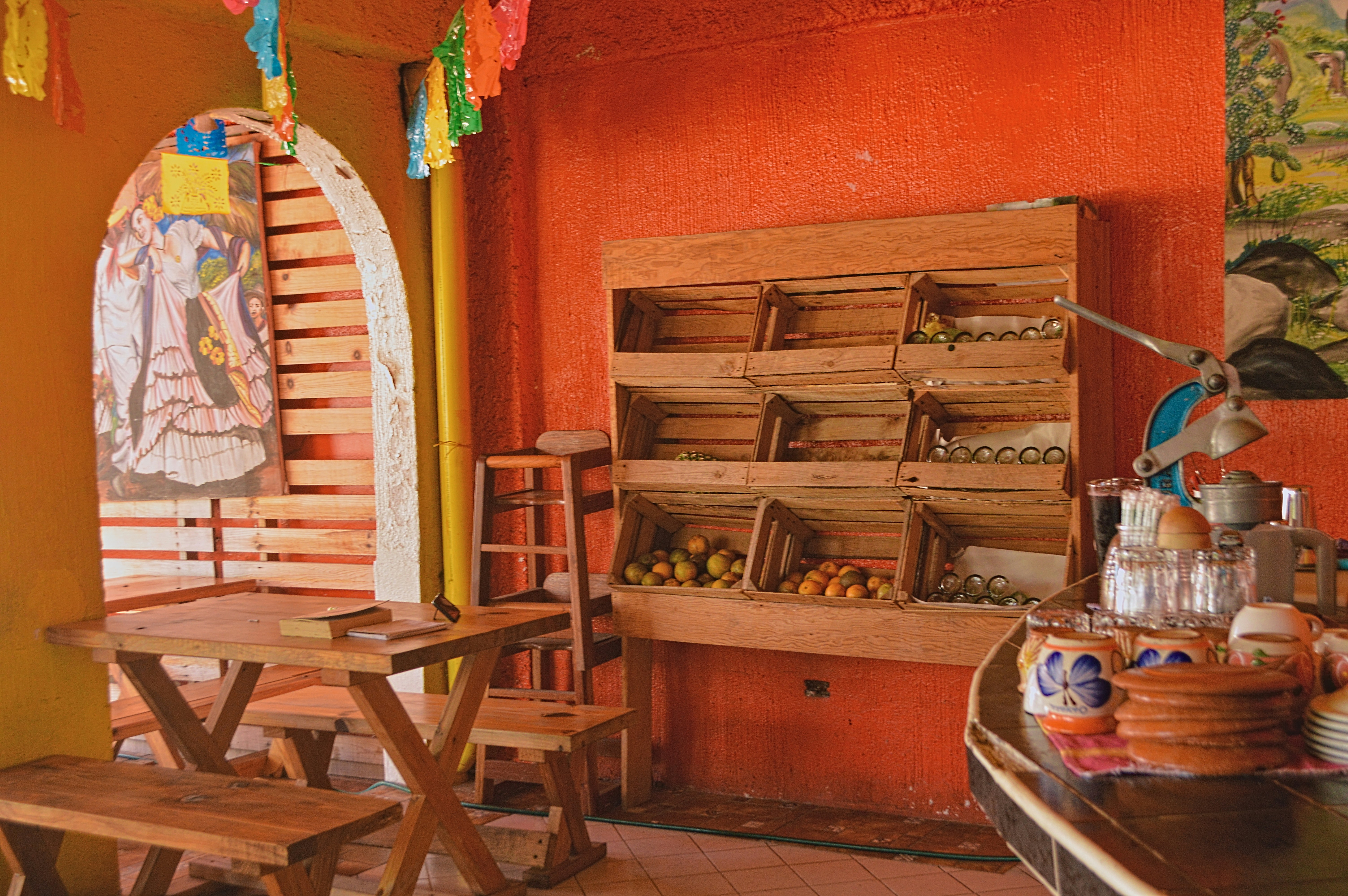 a room with a bunch of wooden chairs and a table