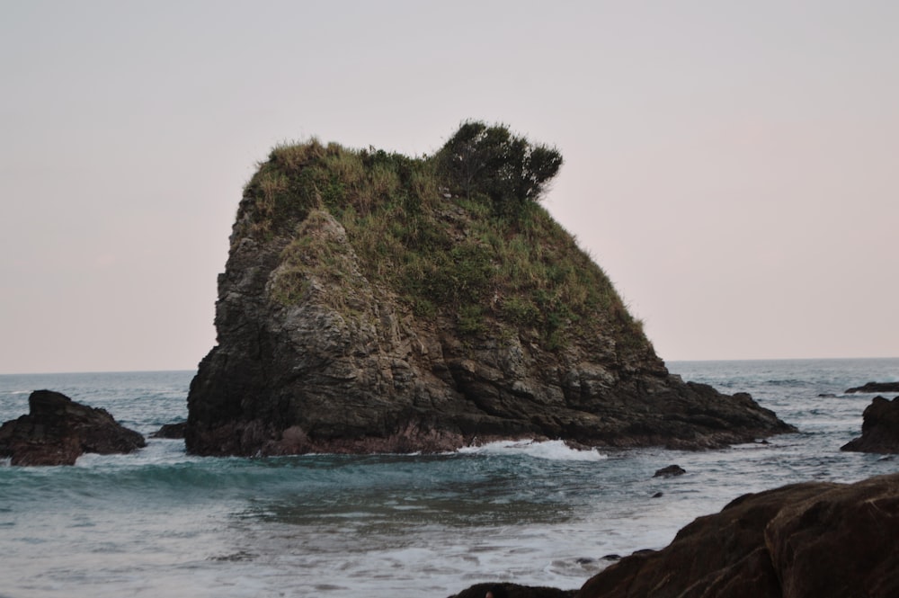 a rock formation in the middle of the ocean