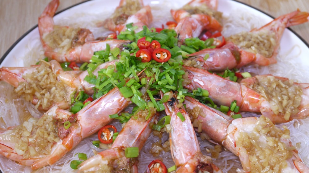 a white plate topped with shrimp and rice