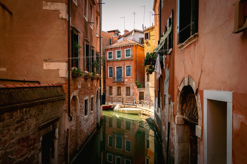a narrow canal runs between two buildings in a city