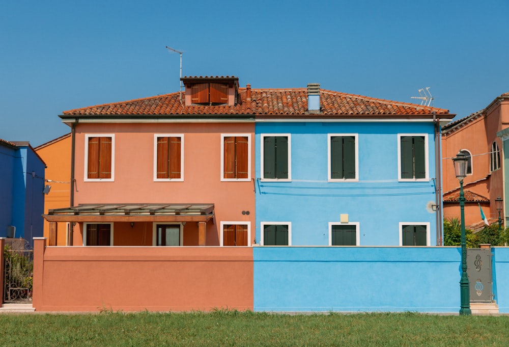 a blue and pink house next to each other