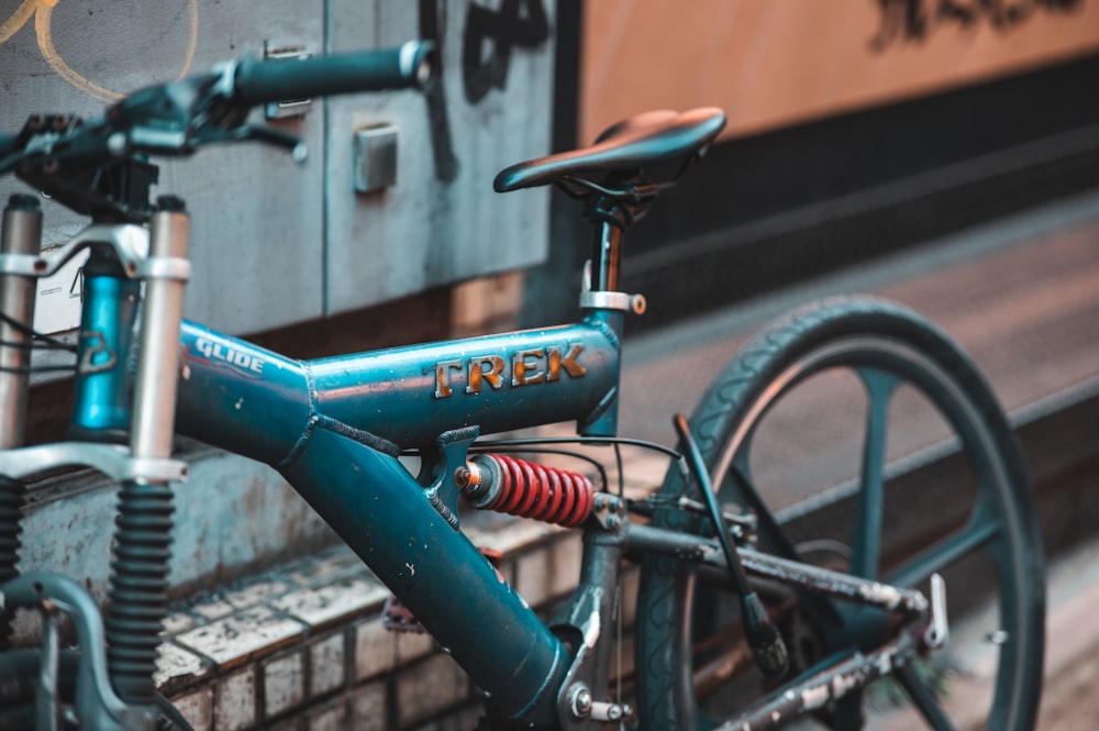 a blue bike parked next to a train