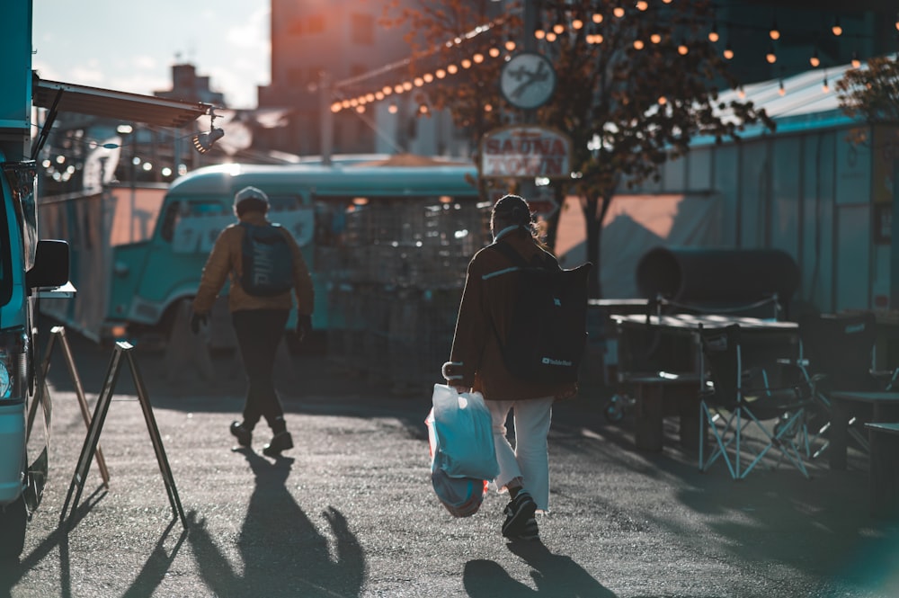 a couple of people walking down a street