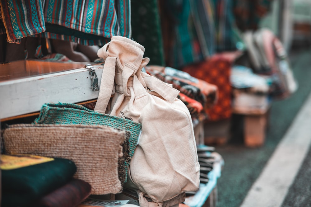 a pile of bags sitting on top of a wooden table