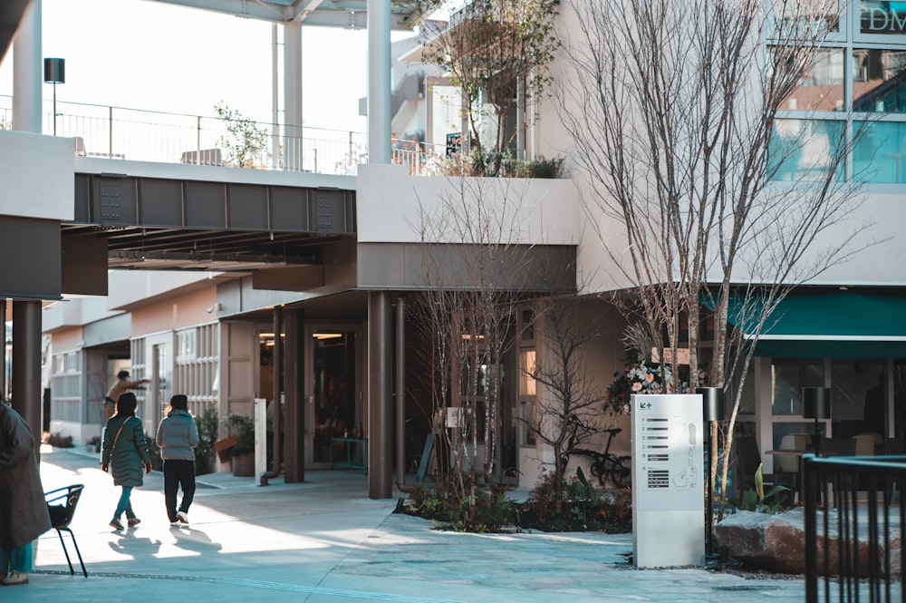 a couple of people that are walking down a sidewalk