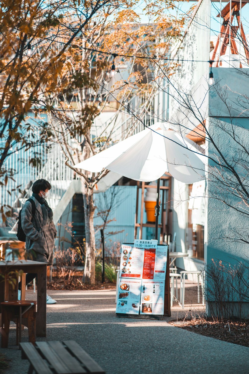 a man standing in front of a blue building