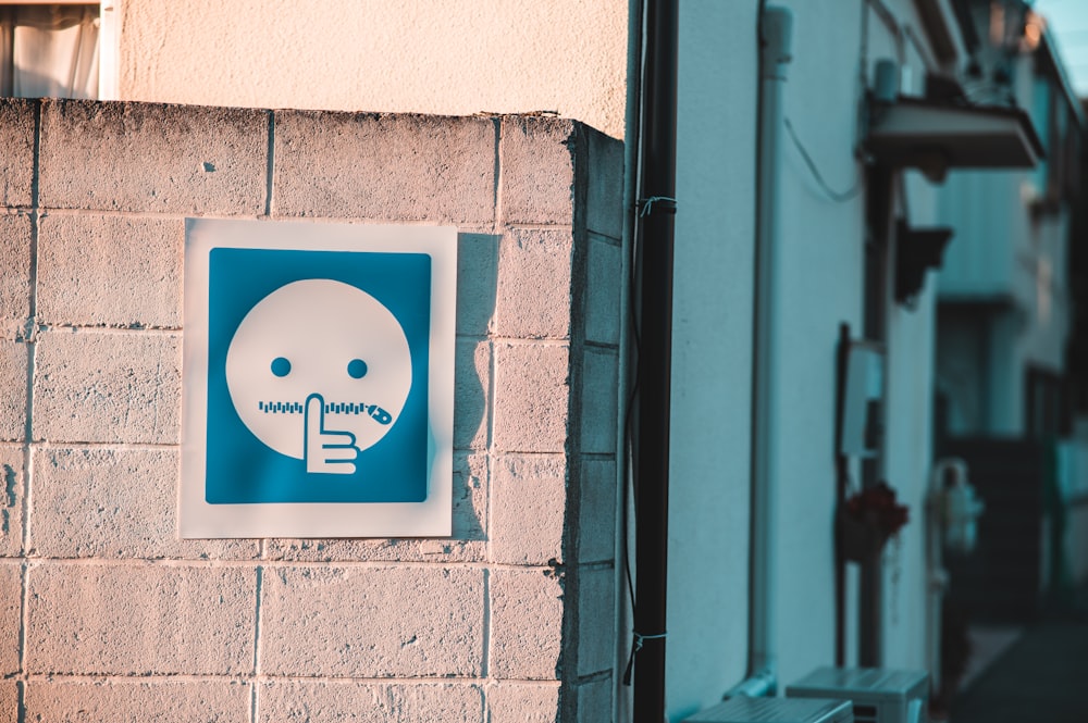 a blue and white sign on the side of a building