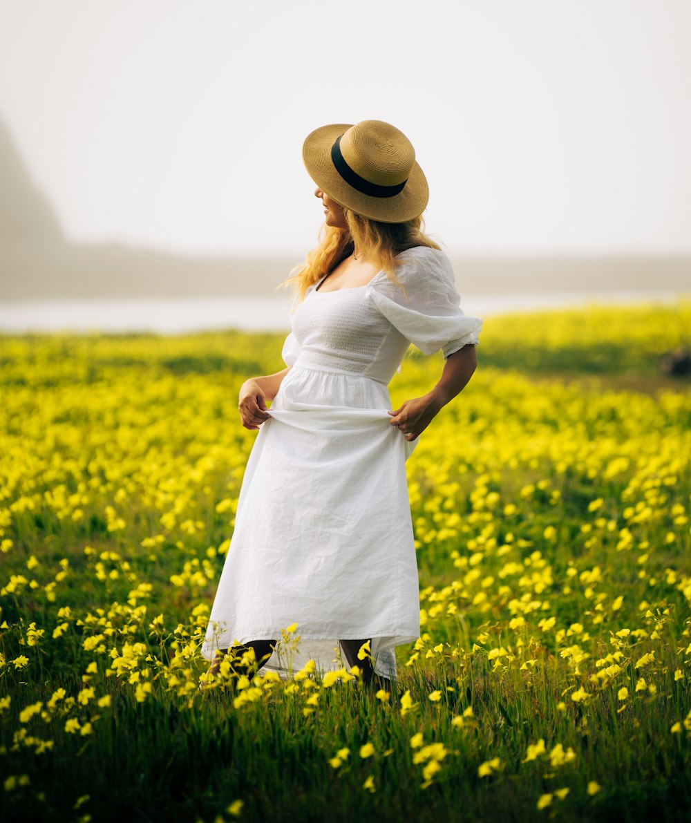 a woman standing in a field of yellow flowers