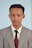 a man in a suit and tie posing for a picture