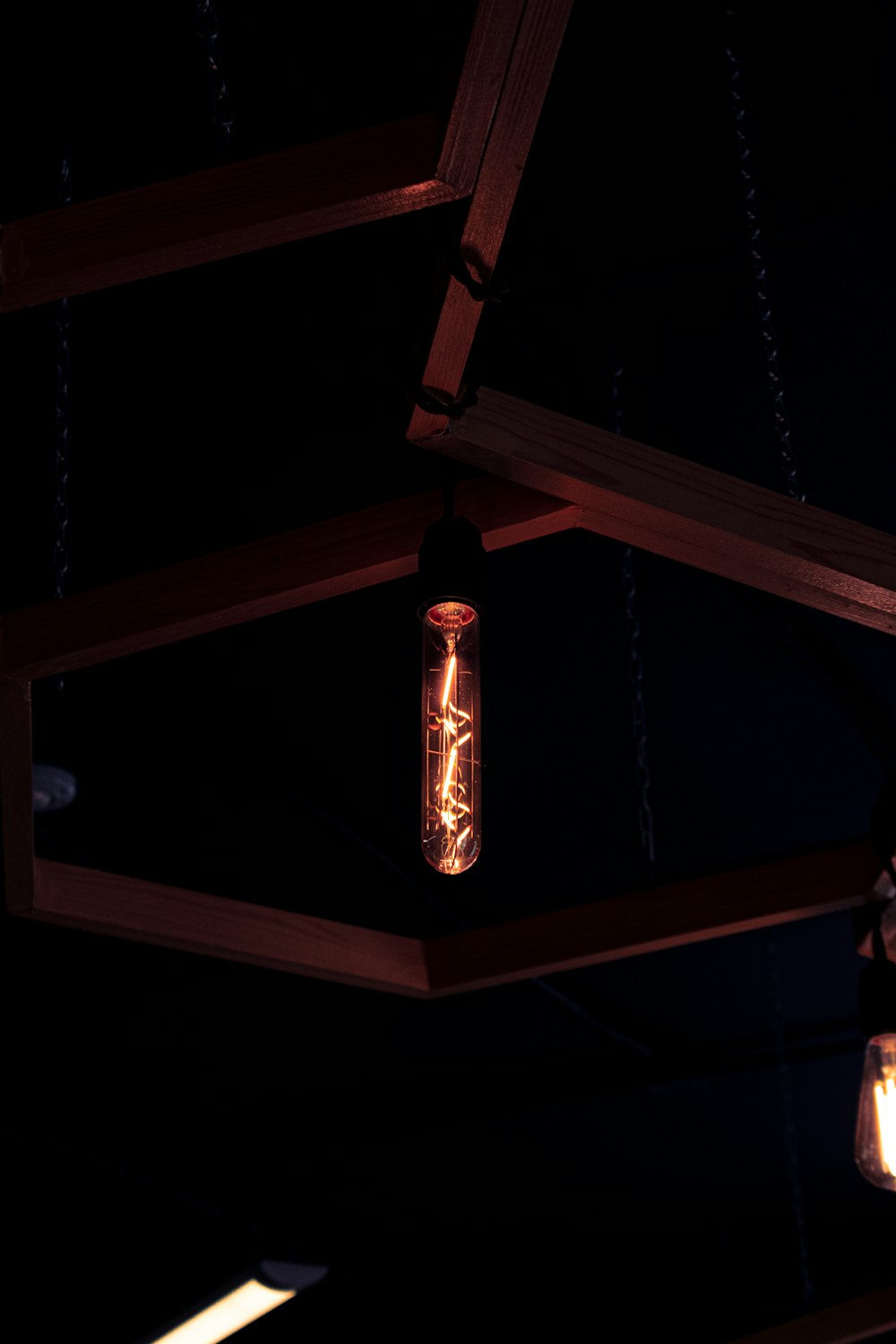 a light bulb hanging from a ceiling in a dark room