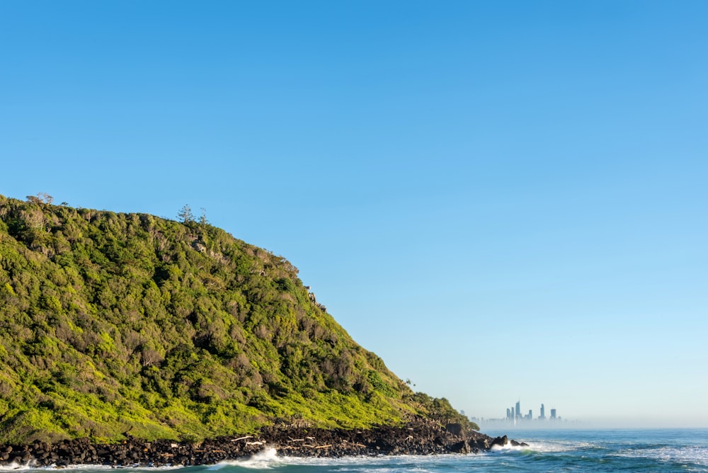 a large hill with a city in the distance