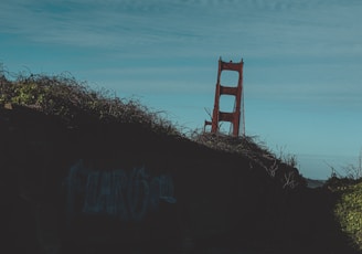 a red chair sitting on top of a hill