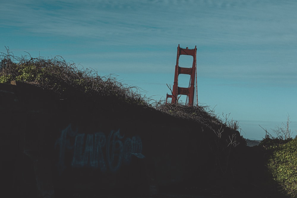 a red chair sitting on top of a hill