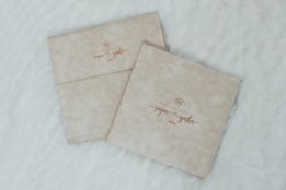 a couple of envelopes sitting on top of a bed