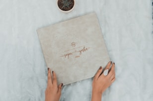 a woman holding a box with a happy new year written on it