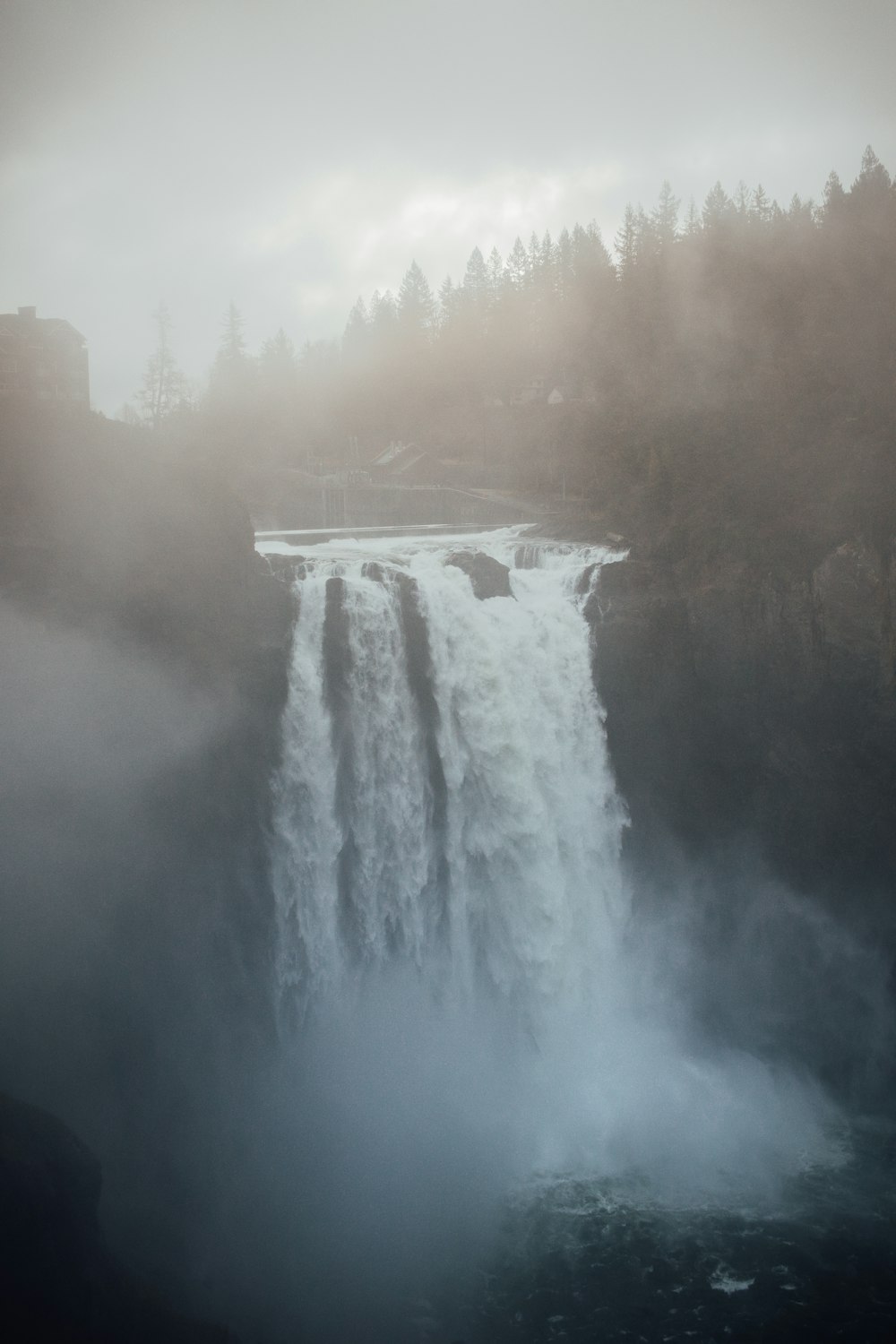 a waterfall in the middle of a forest