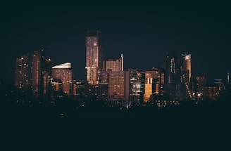 a night view of a city with tall buildings