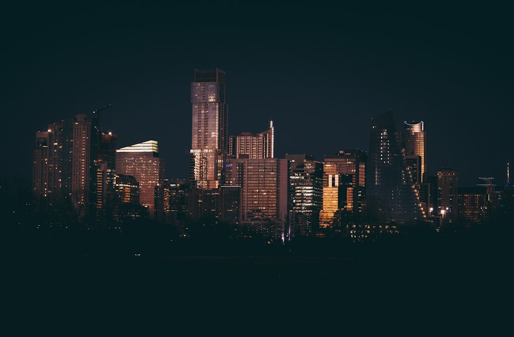 a night view of a city with tall buildings